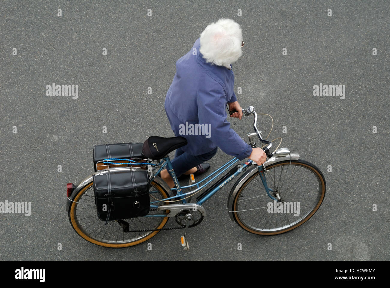 Woman pushing bicycle, France. Stock Photo