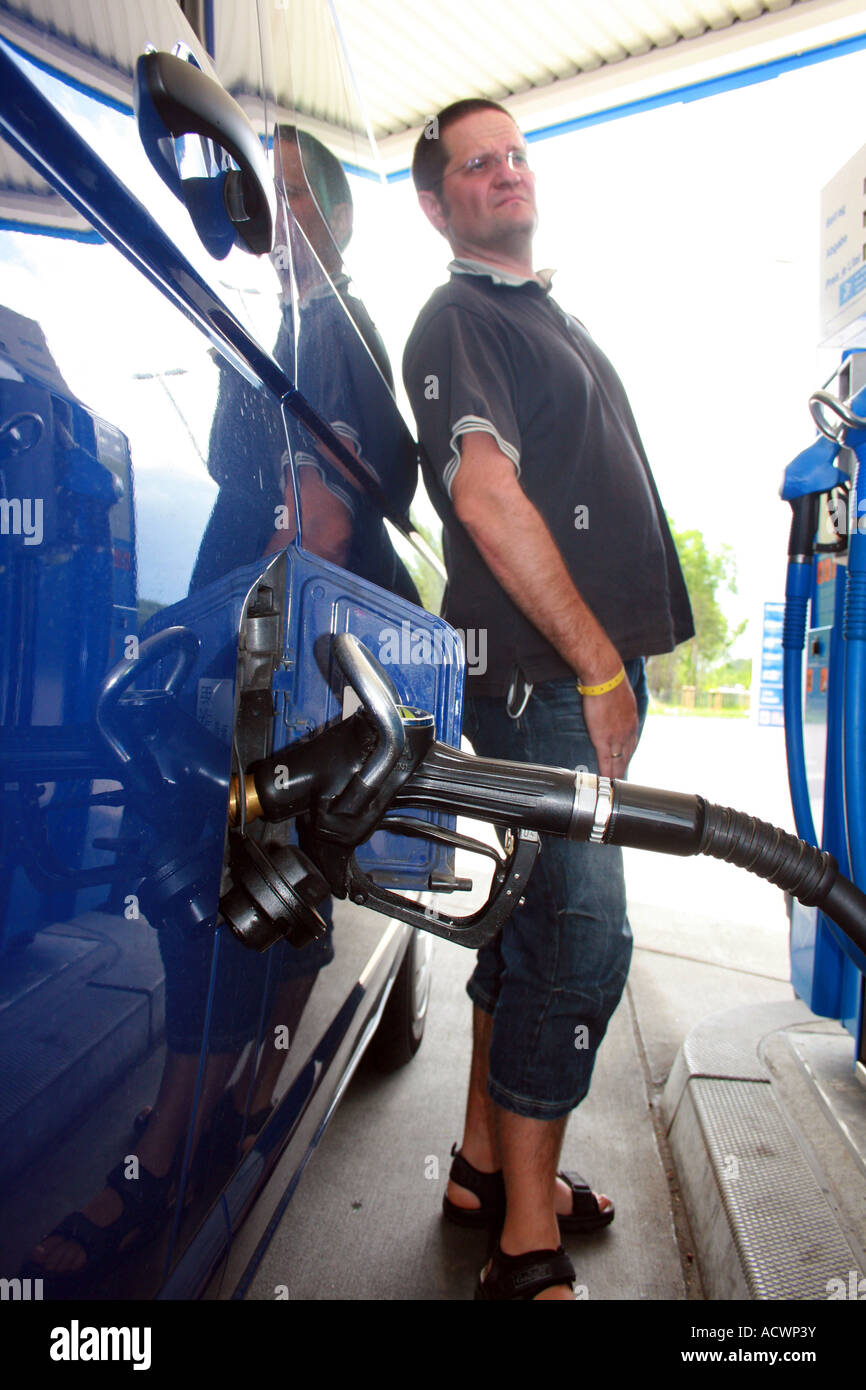 man fueling, watching the fuel prices, Germany Stock Photo Alamy