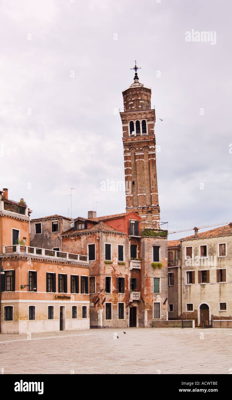 leaning church bell tower Campanile of Chiesa di Santo Stefano in Venice Italy as seen from deserted Campo San Angelo Stock Photo