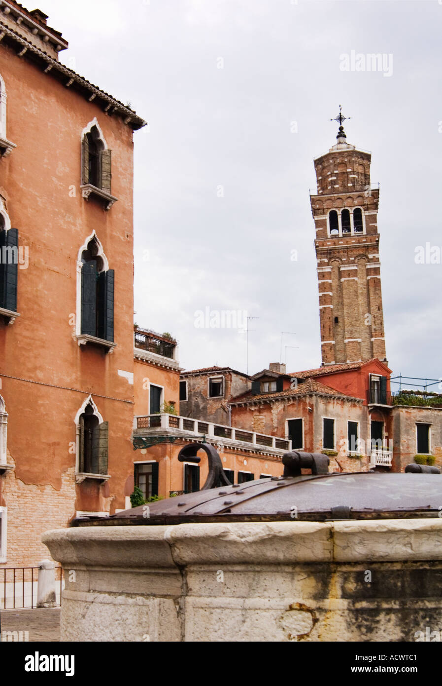 leaning church bell tower of Campanile of Chiesa di Santo Stefano in Venice Italy as seen from the deserted Campo San Angelo Stock Photo