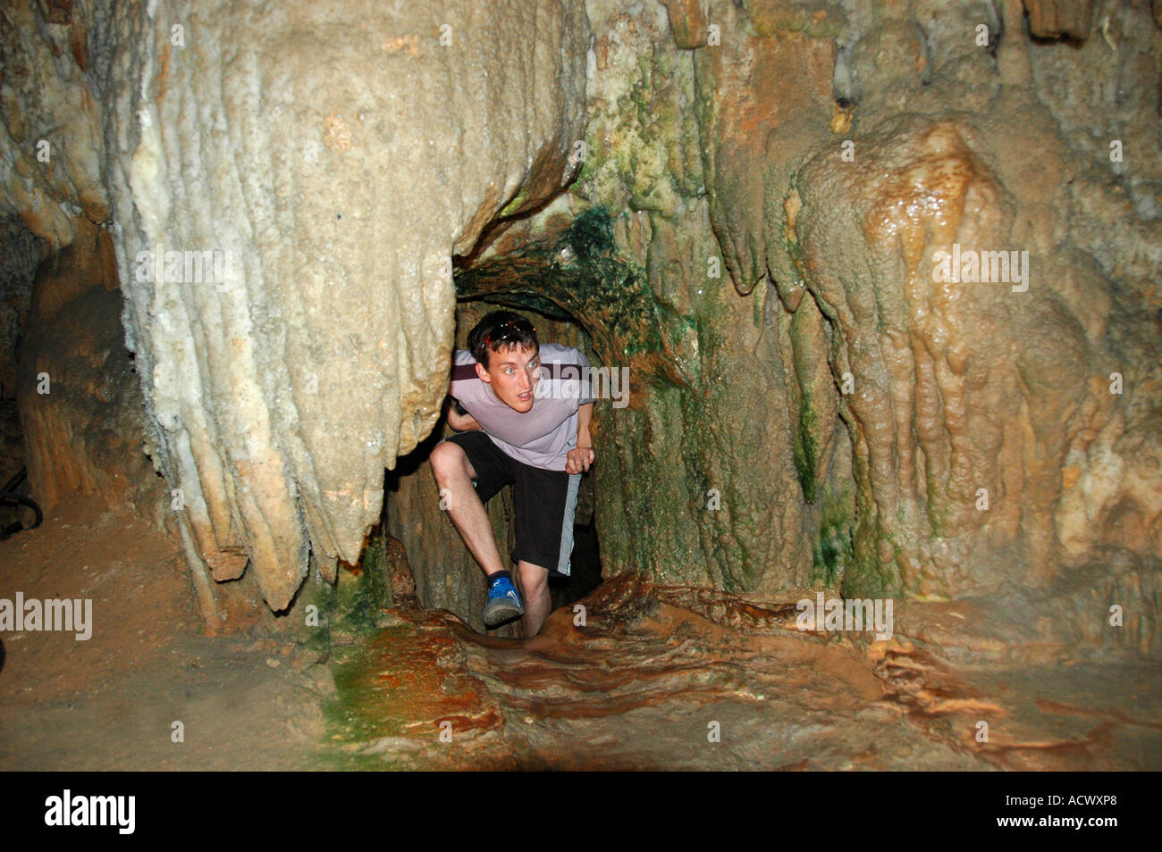 Tourist crawling through narrow tunnel in Cango Caves Oudtshoorn South ...