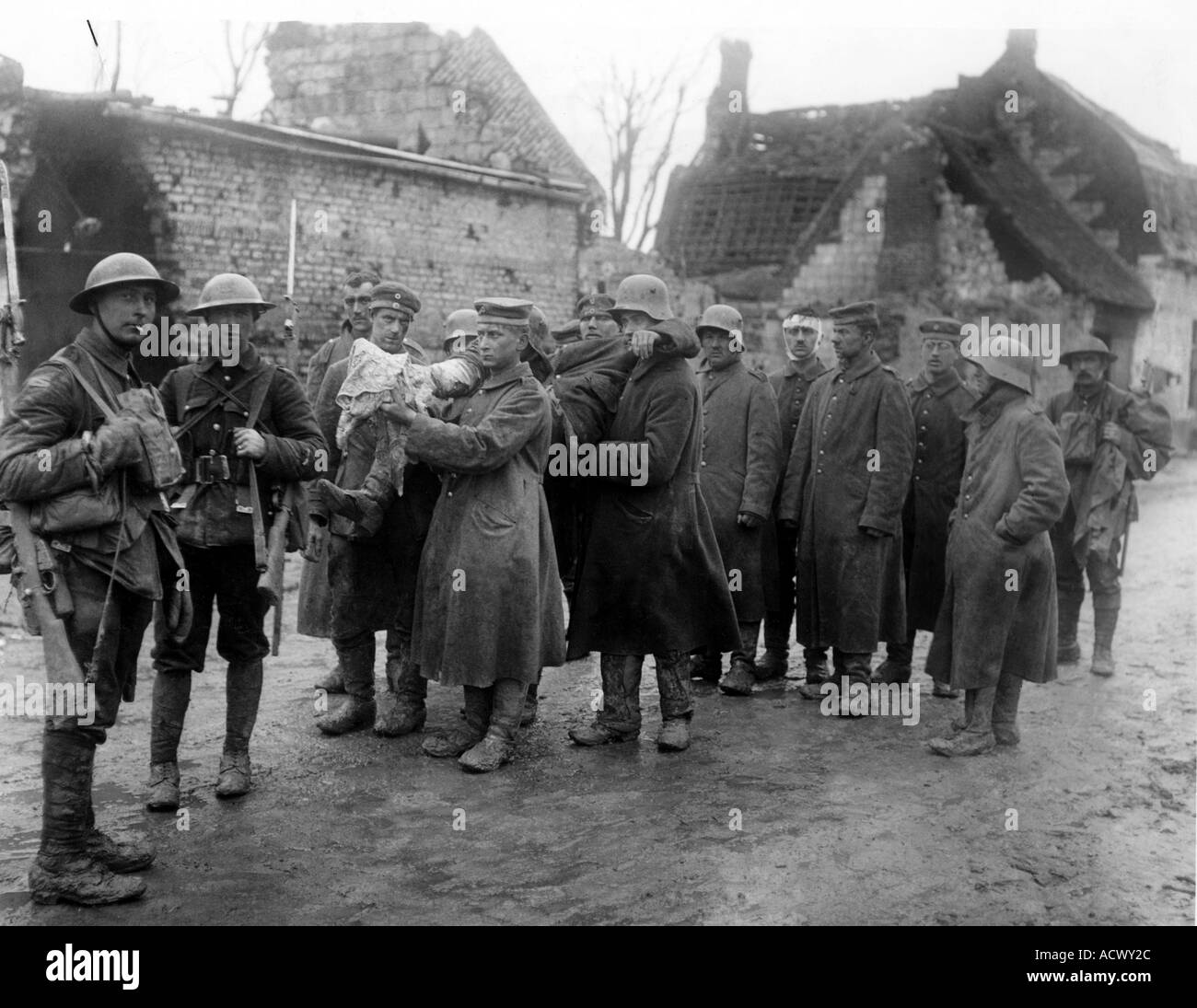 WWI ARRAS April 1917 German prisoners carry one of their wounded escorted at left by by two British soldiers with another bring Stock Photo