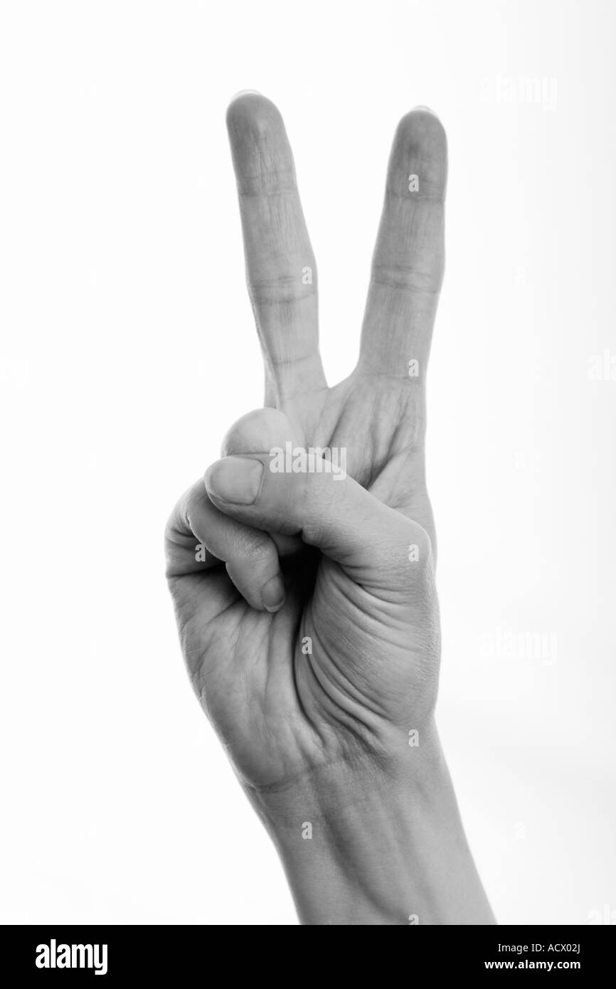 Woman giving peace sign victory sign (black and white image) Stock Photo