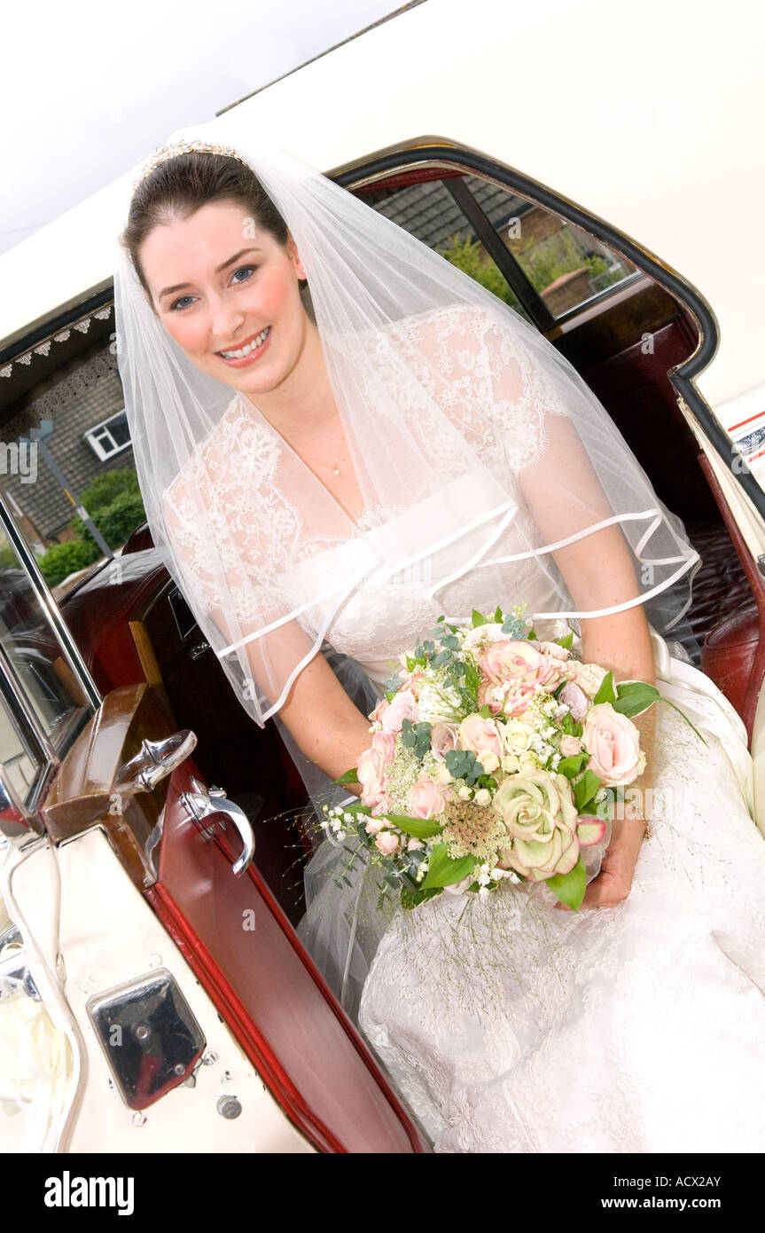 bride getting out of wedding car Stock Photo - Alamy