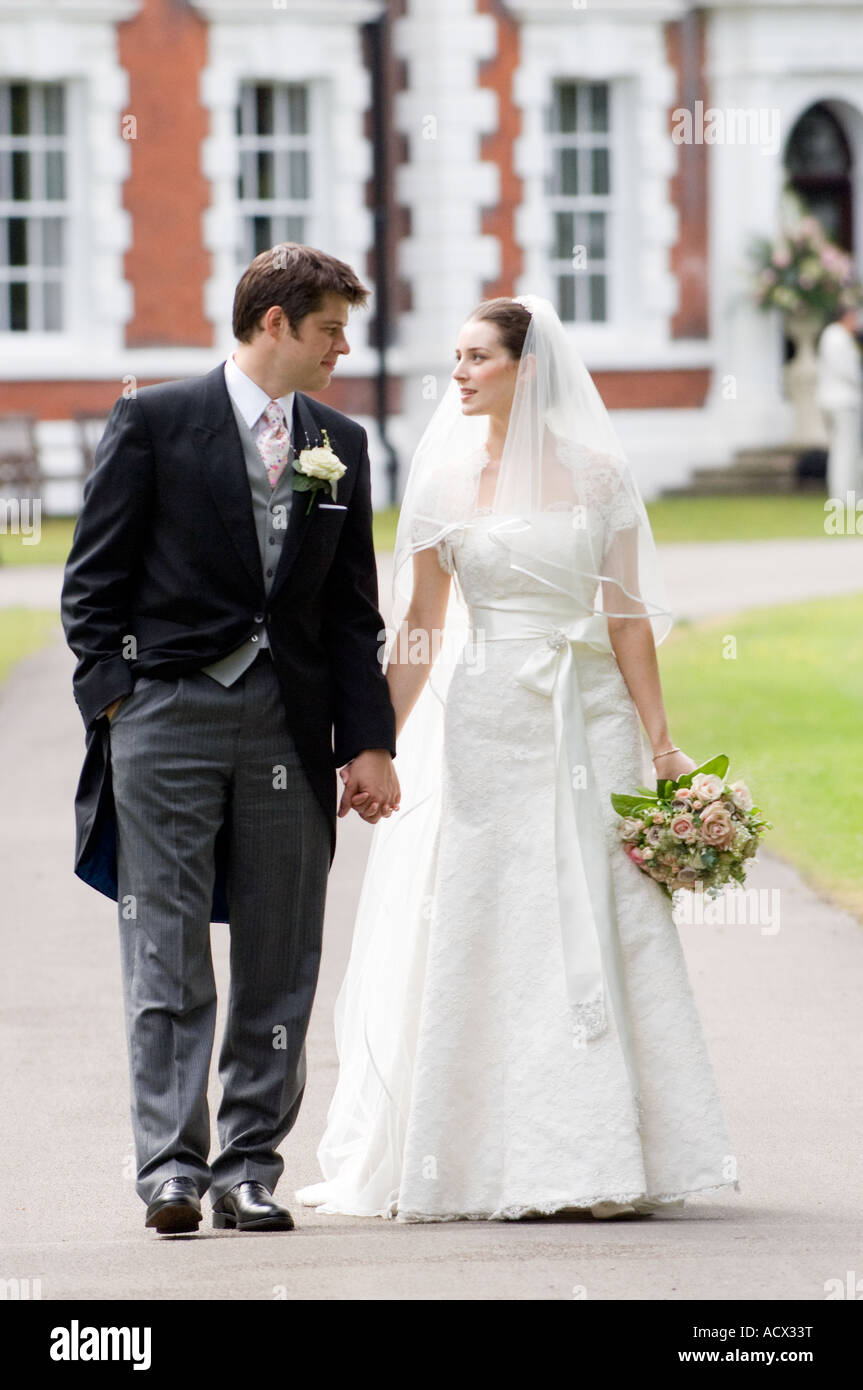 bride and groom walking hand in hand Stock Photo - Alamy