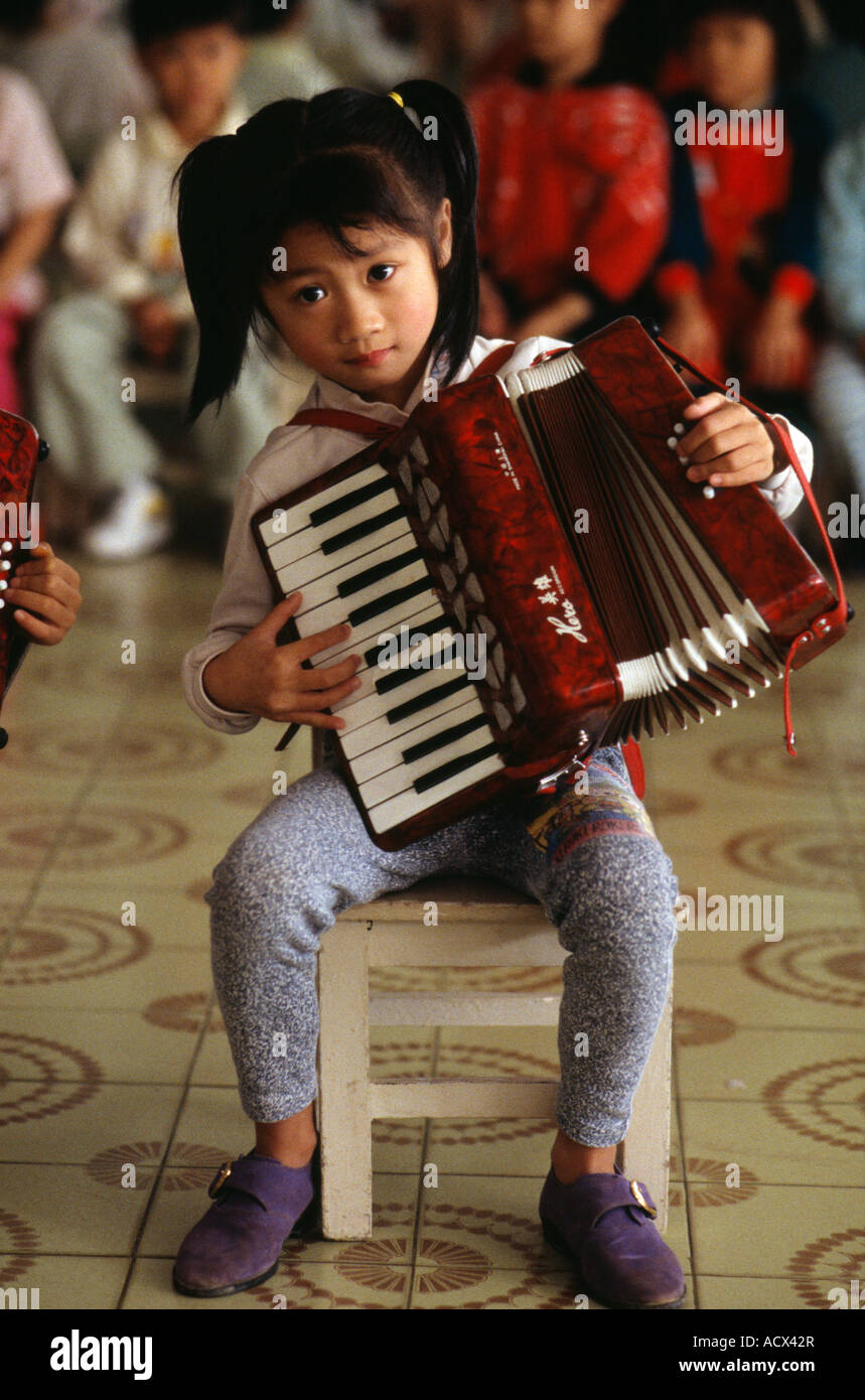 Young girl playing accordion China Stock Photo