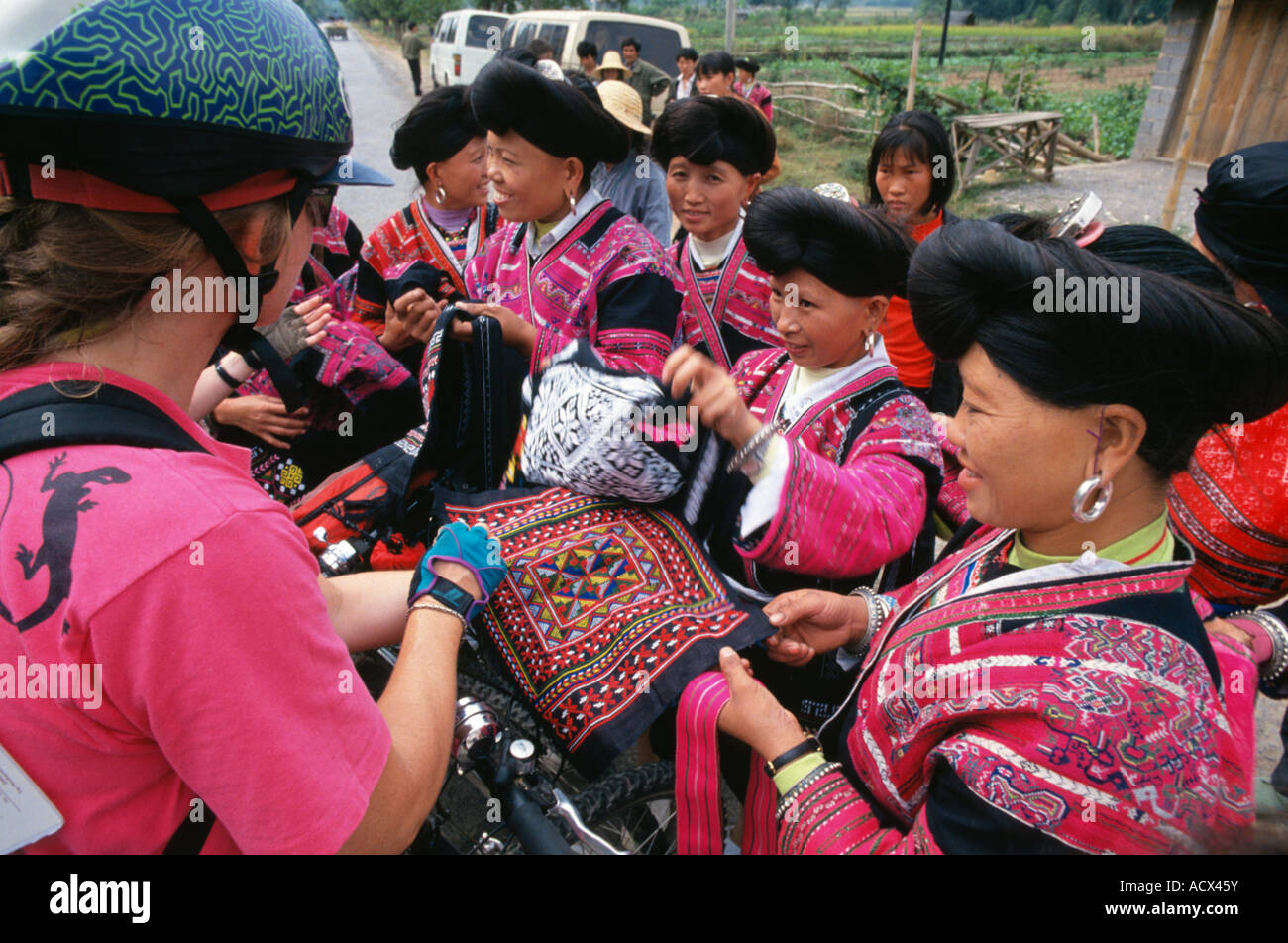 Women in traditional dress selling handicrafts Guanxi China Stock Photo