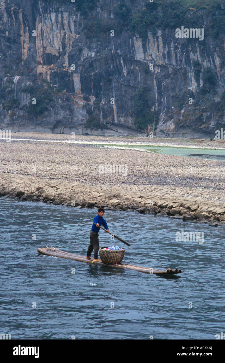 Man on a small boat on the Li River near Guilin Guanxi China Stock Photo