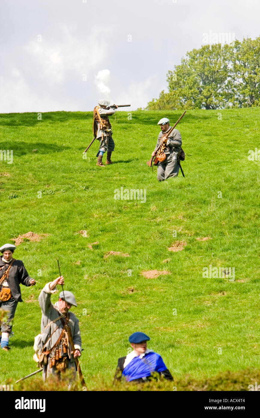 Covenanter troops in uniform skirmish on hill with muskets Stock Photo