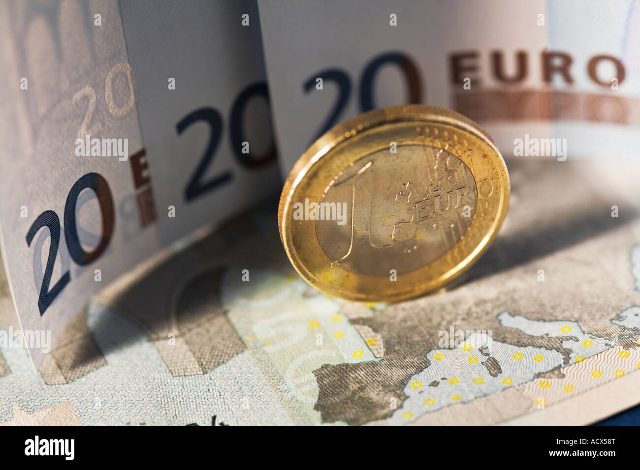 Euro sitting on euro bank notes Stock Photo