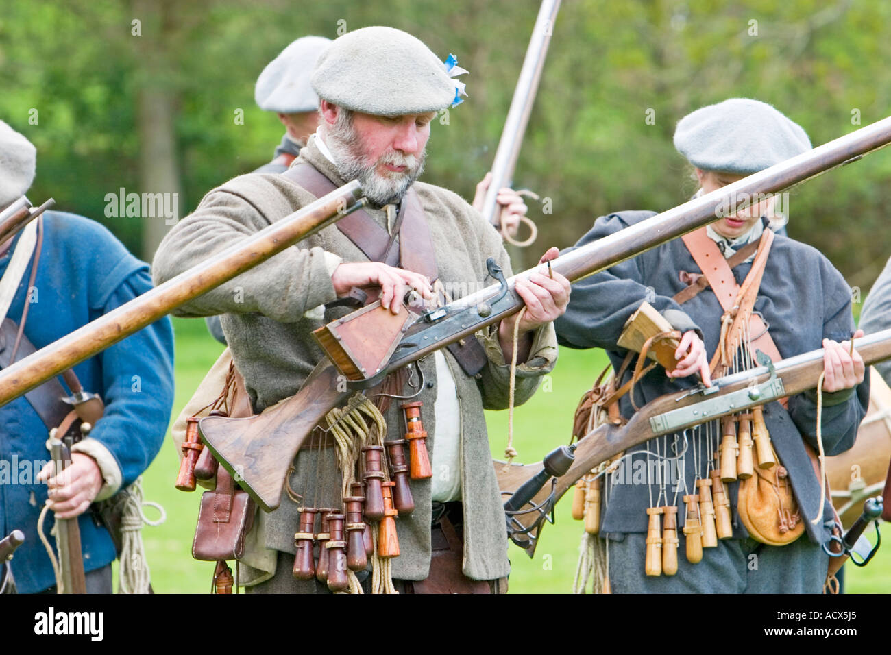 Covenanter soldier primes musket firing mechanism with gunpowder Stock Photo