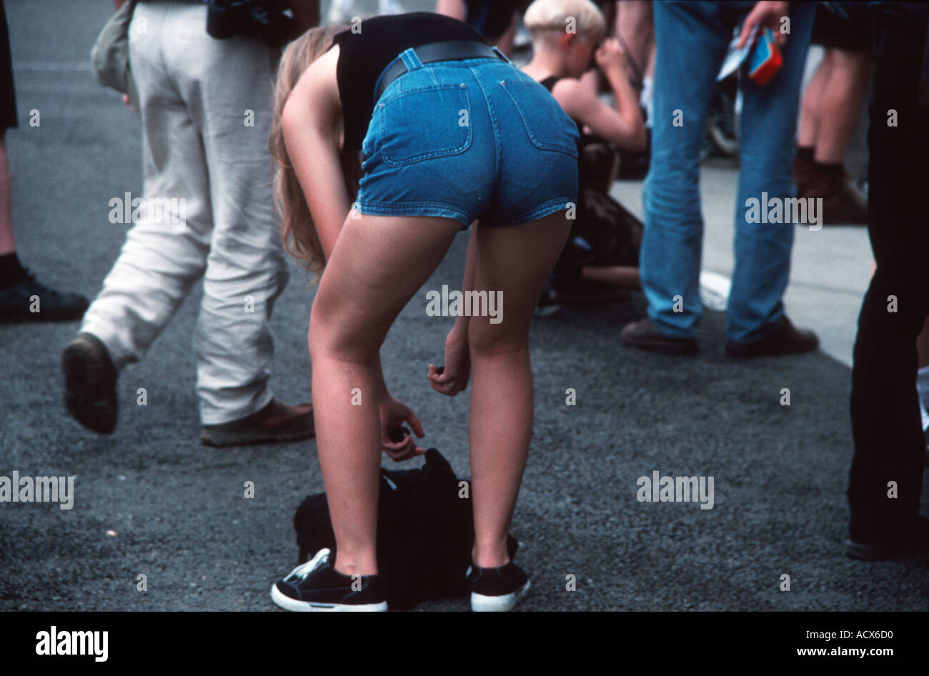 Shapely girl in denim shorts bending over Stock Photo - Alamy