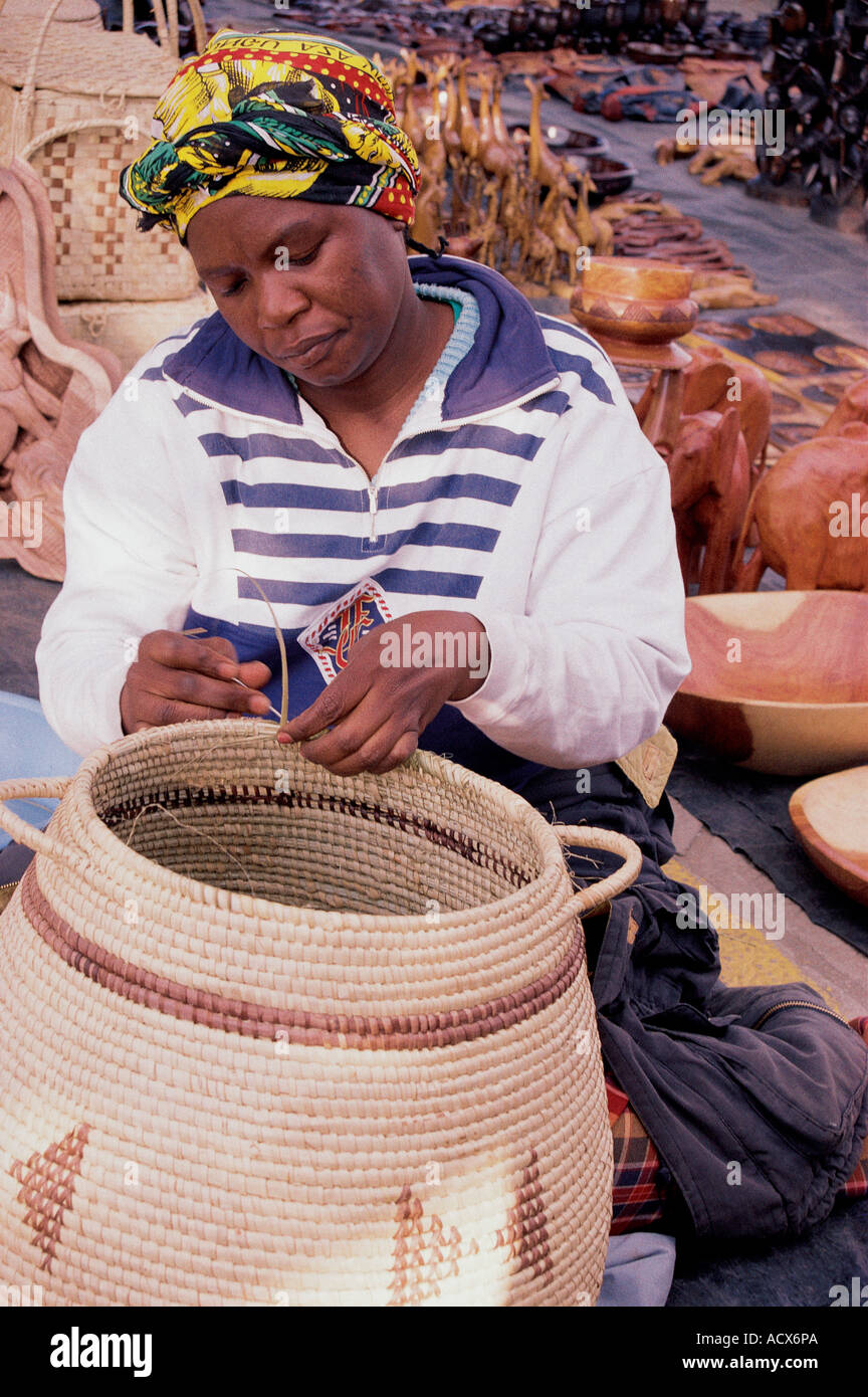 Young woman making a basket on the pavement in Windhoek Namibia south