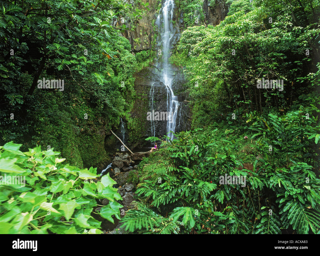 Female visiting Wailua Falls at Hana Coast on Island of Maui Stock Photo