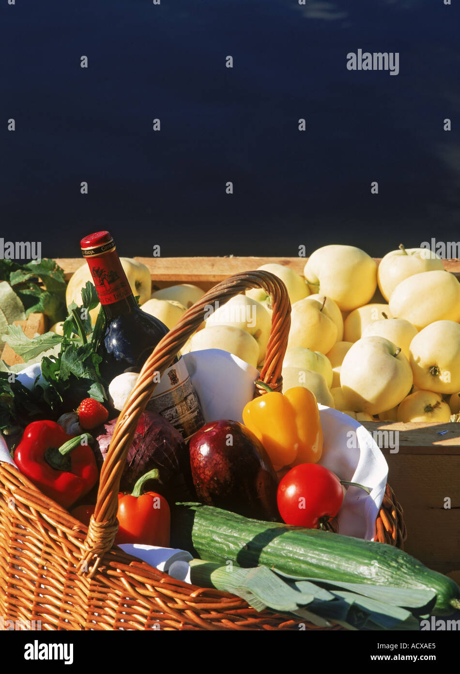Picnic basket of fruits and vegetables with bottle of red wine Stock ...
