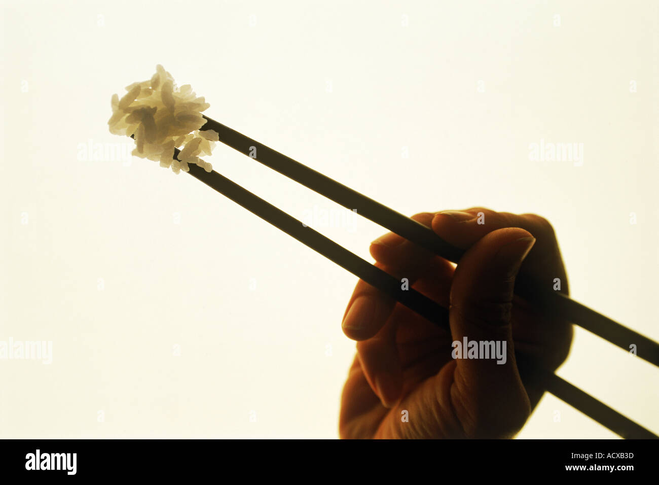 Chopsticks holding rice Stock Photo