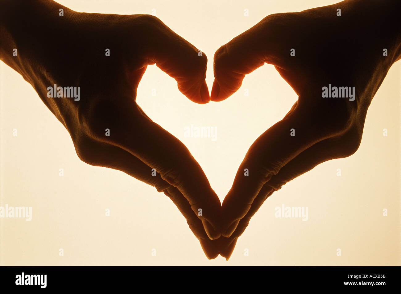 Two hands forming one heart Stock Photo
