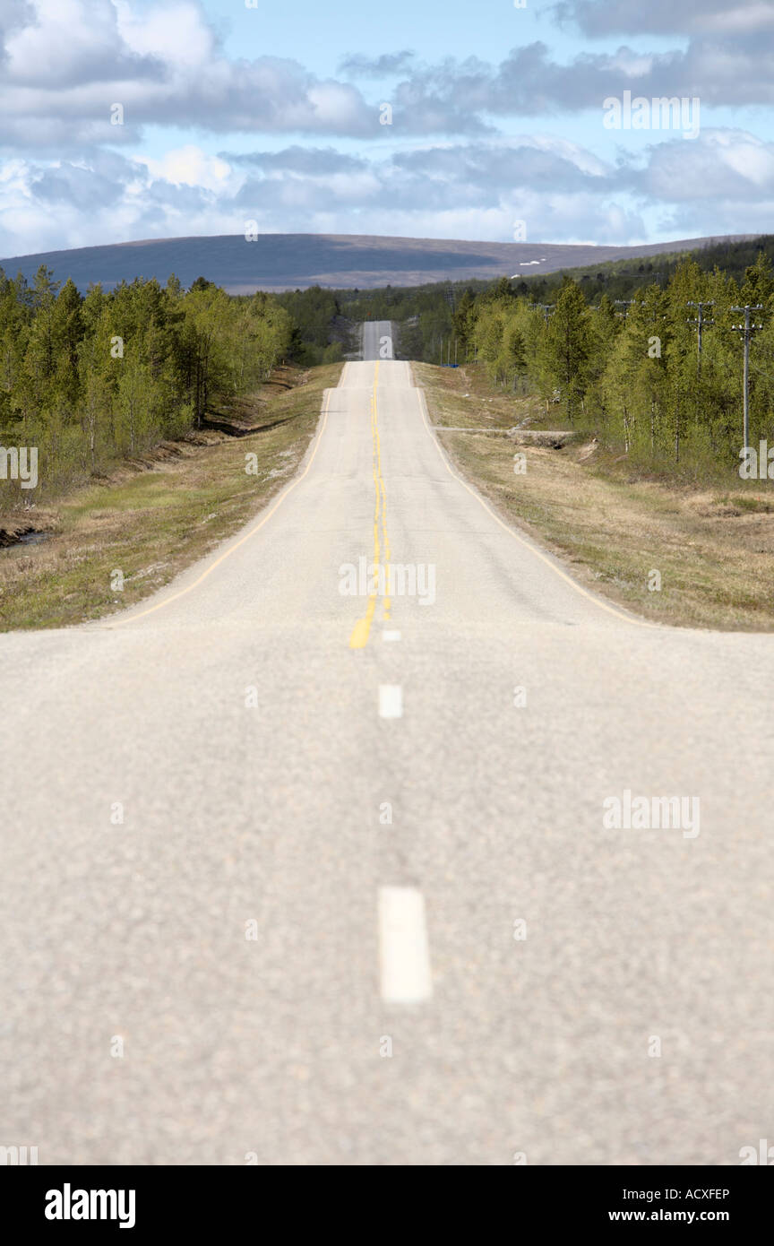 Undulating road amidst forest and hills, Enontekiö municipality ...