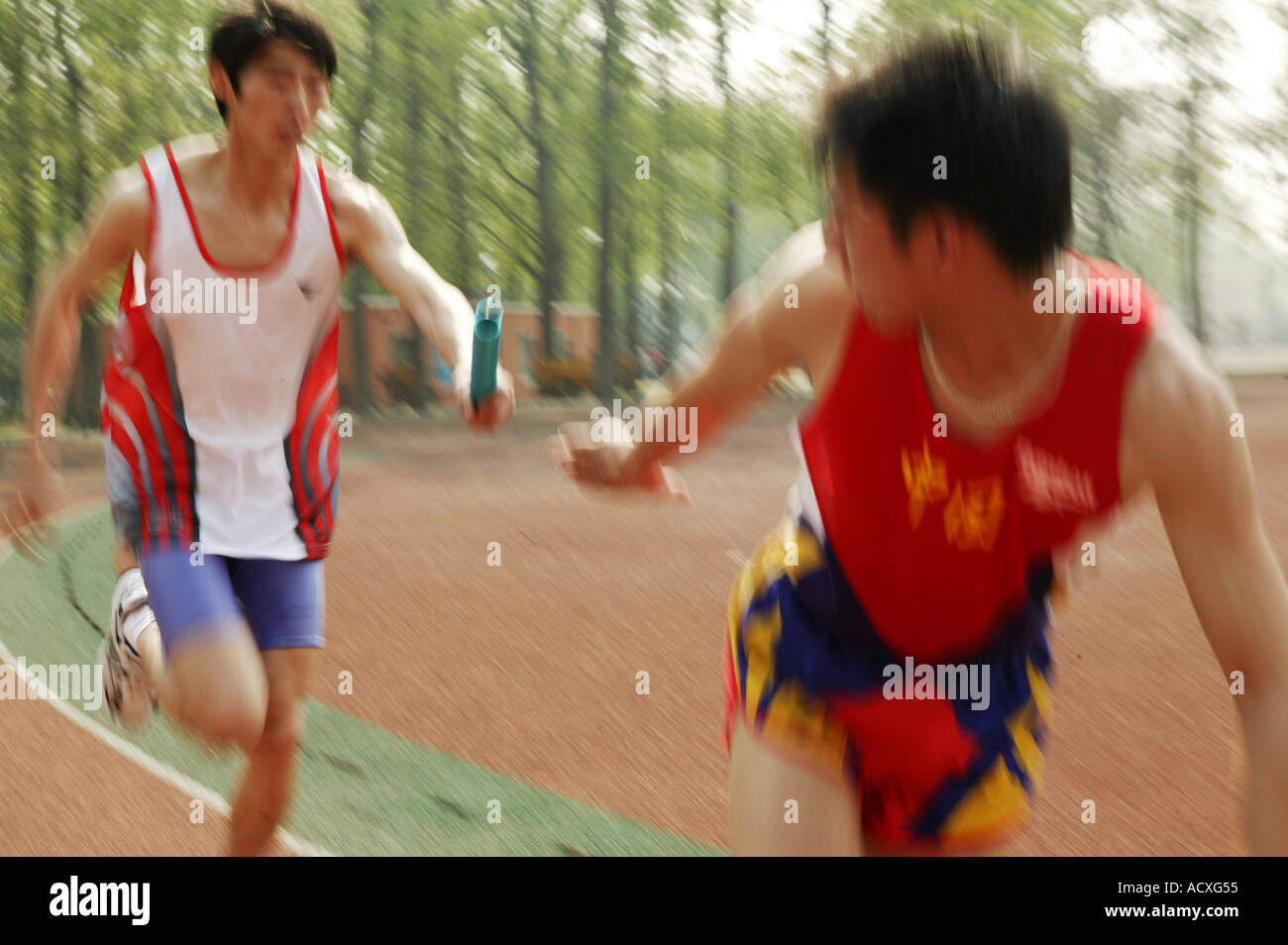 Athletes running passing baton hi-res stock photography and images - Alamy