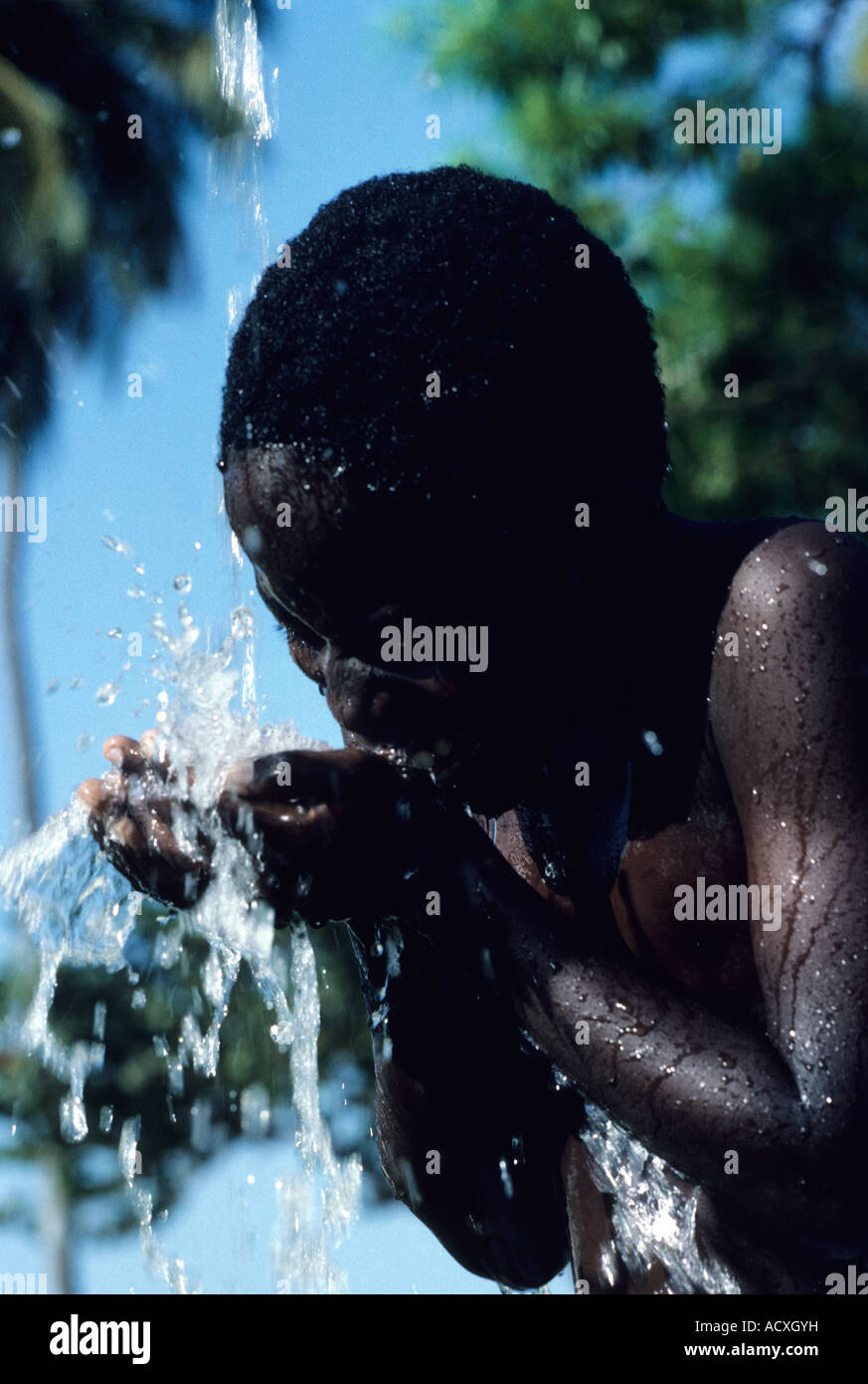 Grenada ,Boy drinking water from waterfall Stock Photo Alamy