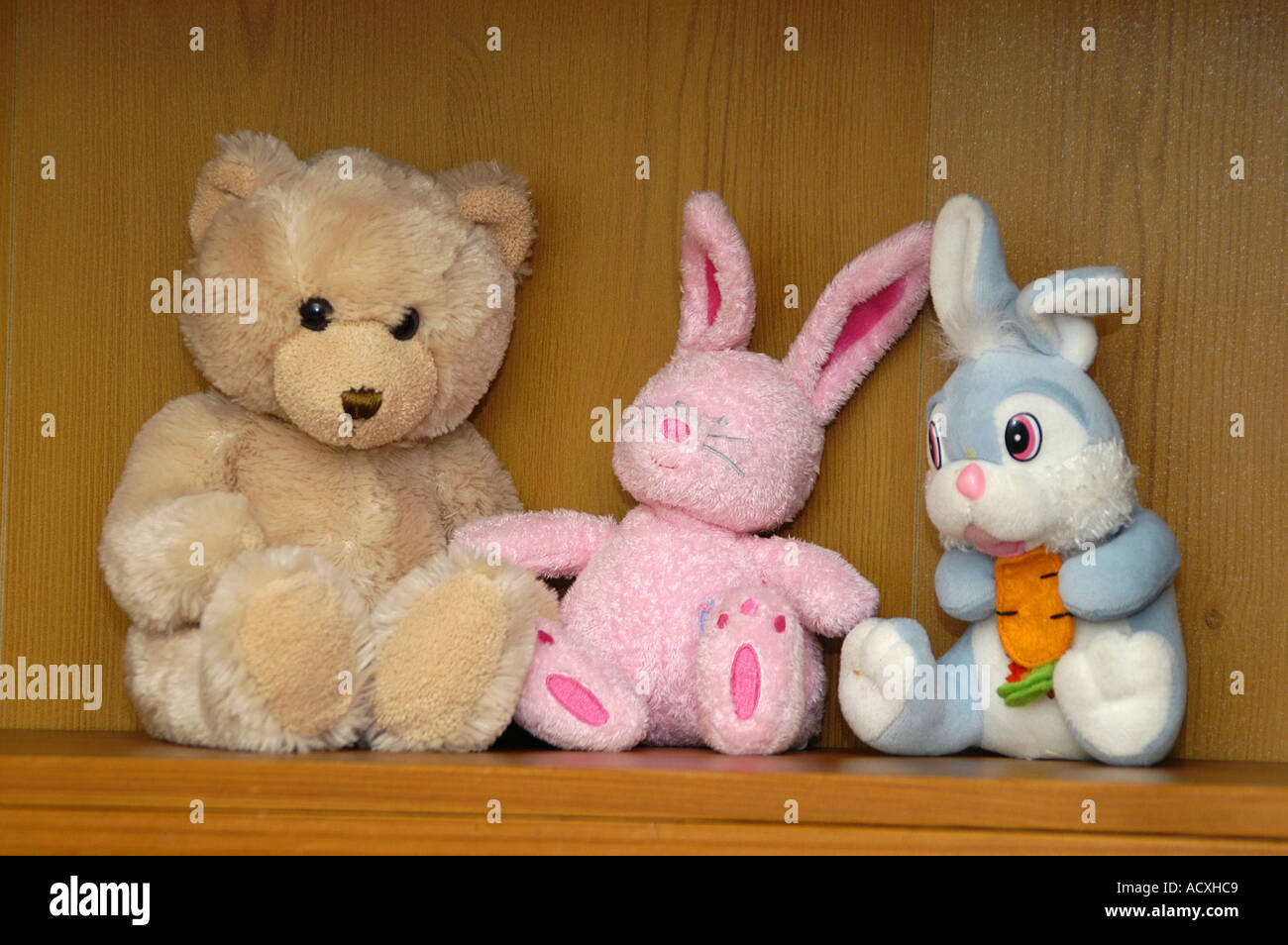 tree toys pink blue rabbit bunny bear brown shelf animal stuffed figure soft  toy cuddly looking children character plaything gam Stock Photo - Alamy
