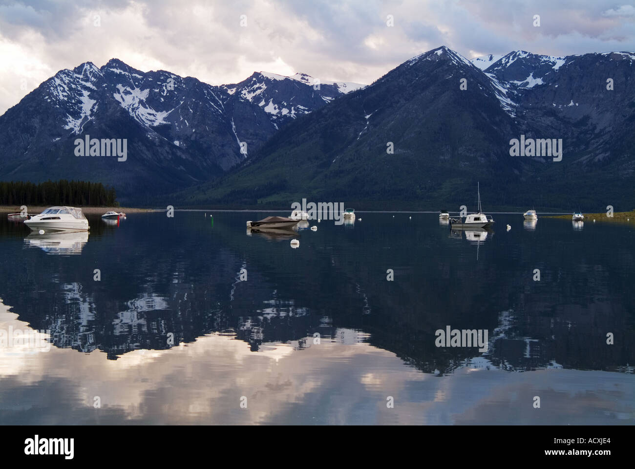 Boats resting quietly in Leeks Marina at Jackson Lake Wyoming Stock
