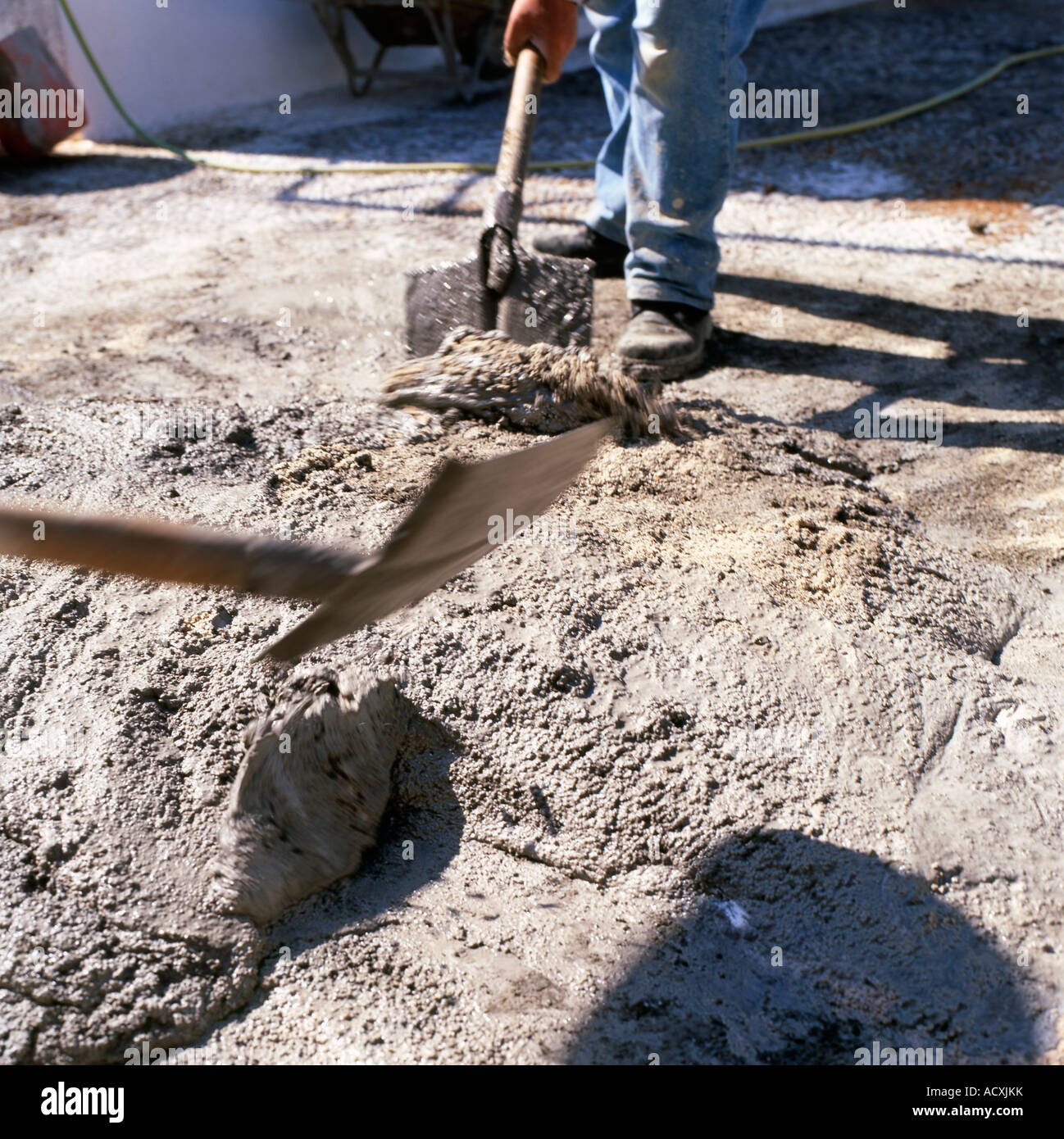 A man mixing concrete cement with a shovel in Santorini Greece Stock Photo Alamy