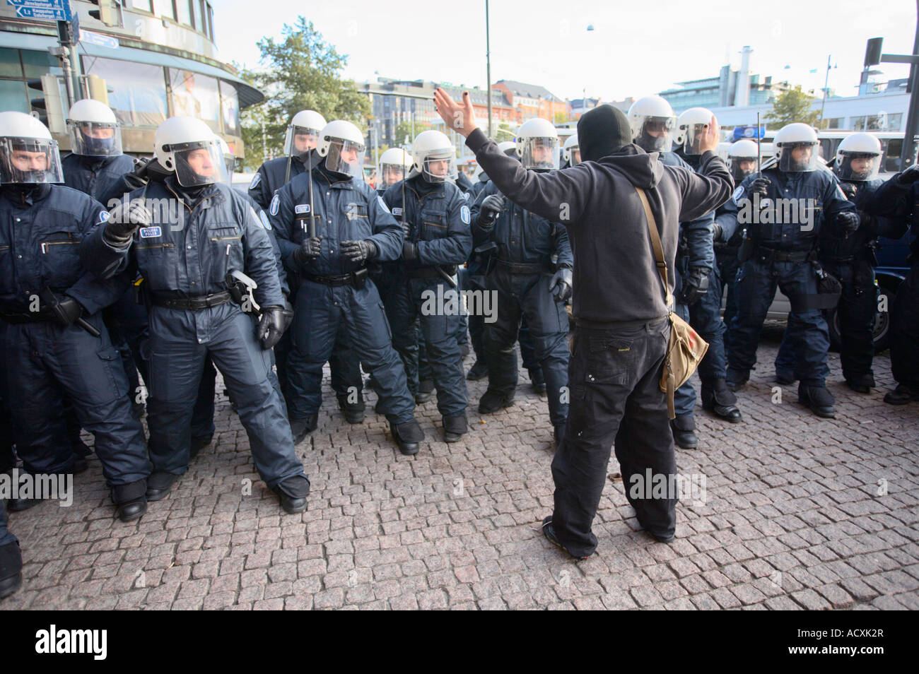 Police officers in riot gear and a person at ASEM demonstration, Helsinki, Finland, EU Stock Photo