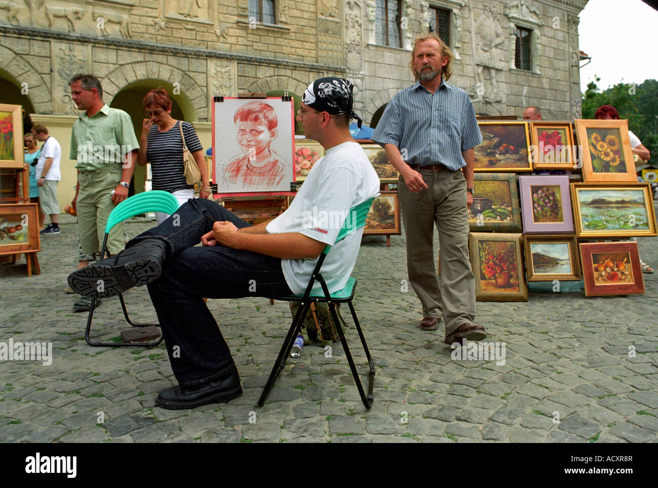 Man selling portraits in the Old Market Square in Kazimierz Dolny
