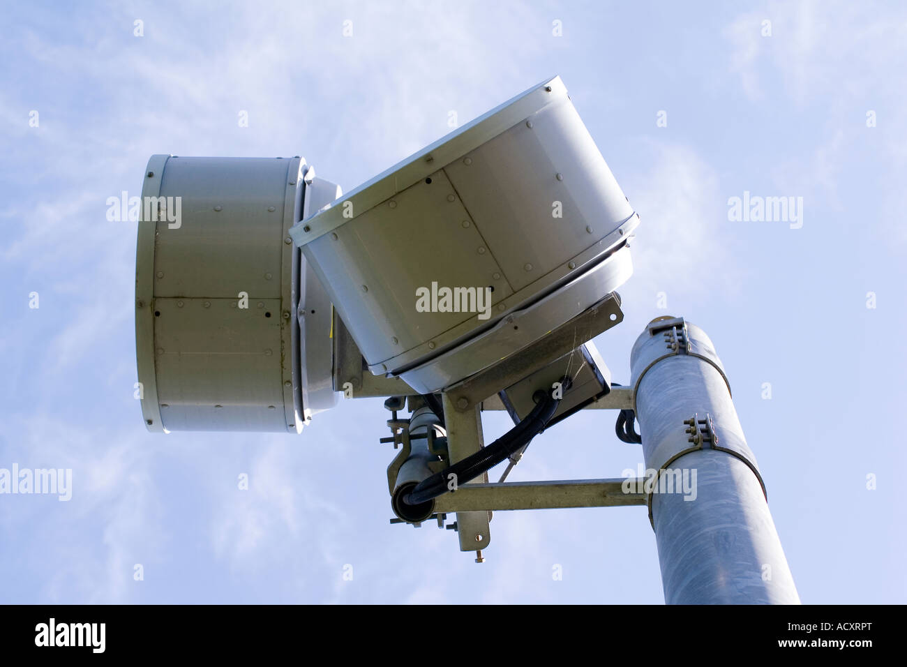 Closeup Of Microwave Dish On High Antenna Tower And Blue Sky