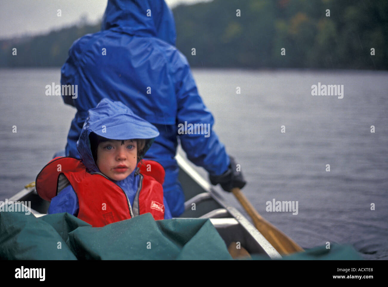 Mother and daughter canoeing in the rain in Algonquin Provincial Park