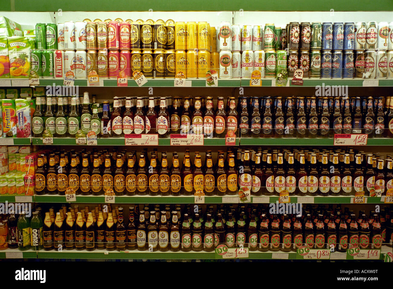 Beer bottles and cans on shelves in a supermarket, Poland Stock Photo