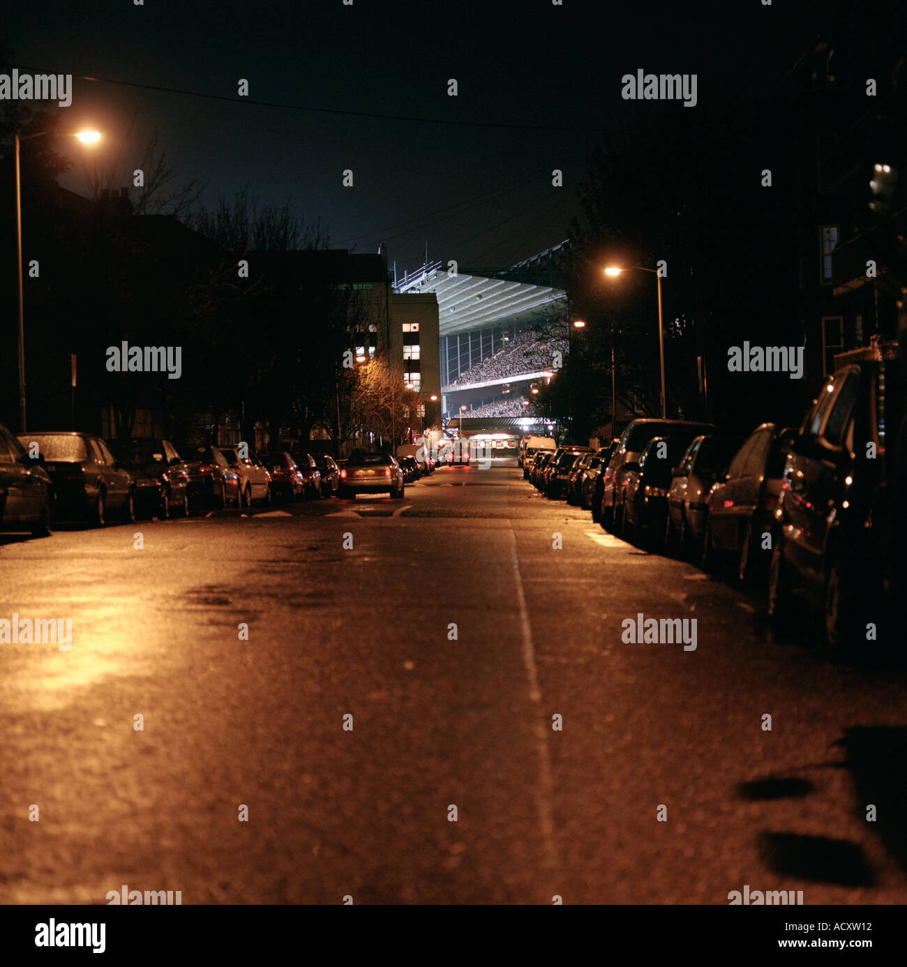 Outside Arsenal Football Club s Highbury Stadium during an evening game looking towards the North Bank Stock Photo