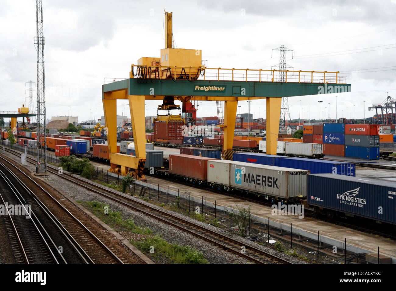 Rail mounted crane loading containers from rail carriages onto truck at Southampton Docks, England. Stock Photo