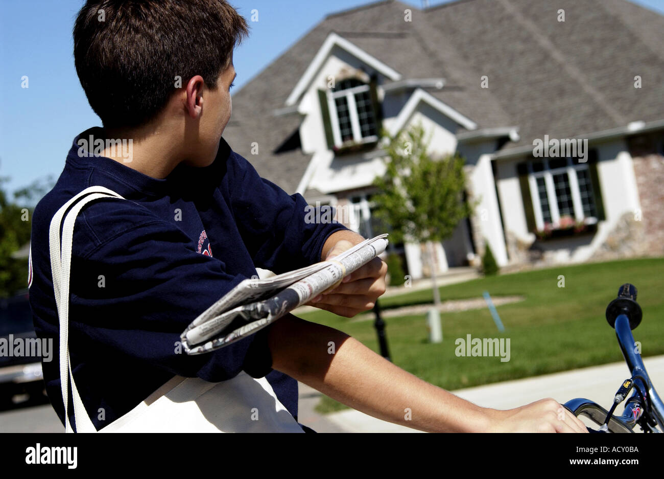 Boy delivering newspaper Stock Photo Alamy