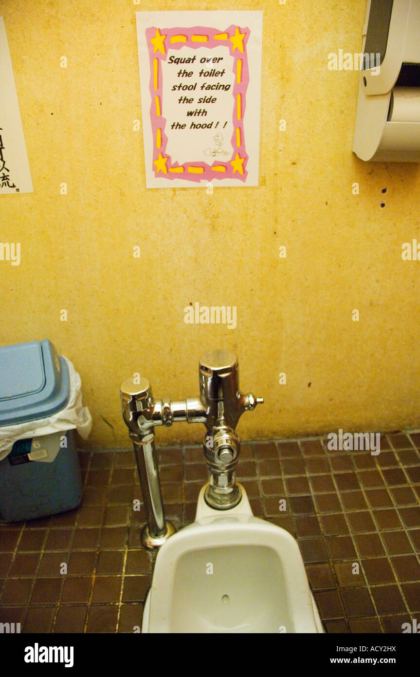Japan Japanese Style Squat Toilet with Funny Instructions on how to use Stock Photo