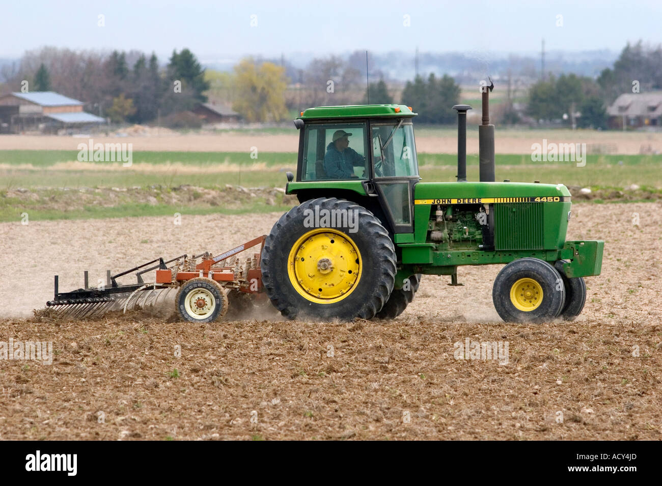 Tractor spring tilling the soil in Twin Falls County, Idaho Stock Photo