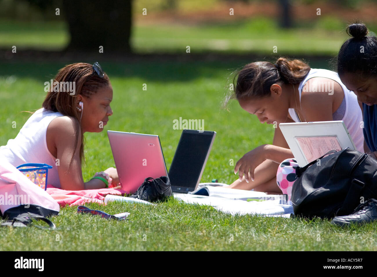 African american female students study using laptop computers on the lawn of Albion College in Michigan. Stock Photo