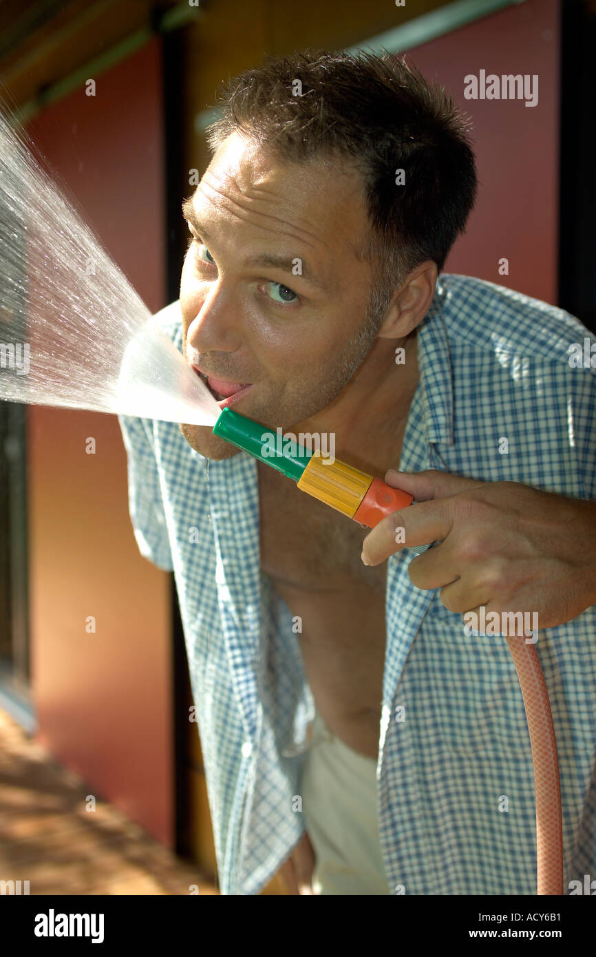 Man drinking from garden hose hires stock photography and images Alamy