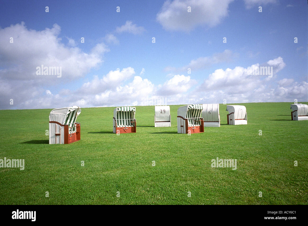wicker beach chairs in a meadow Stock Photo