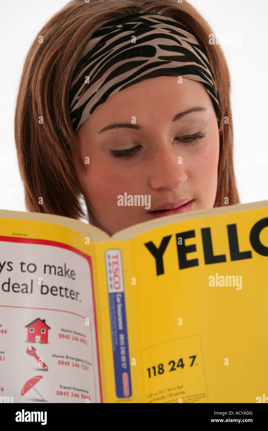"girl reading yellow pages" Stock Photo