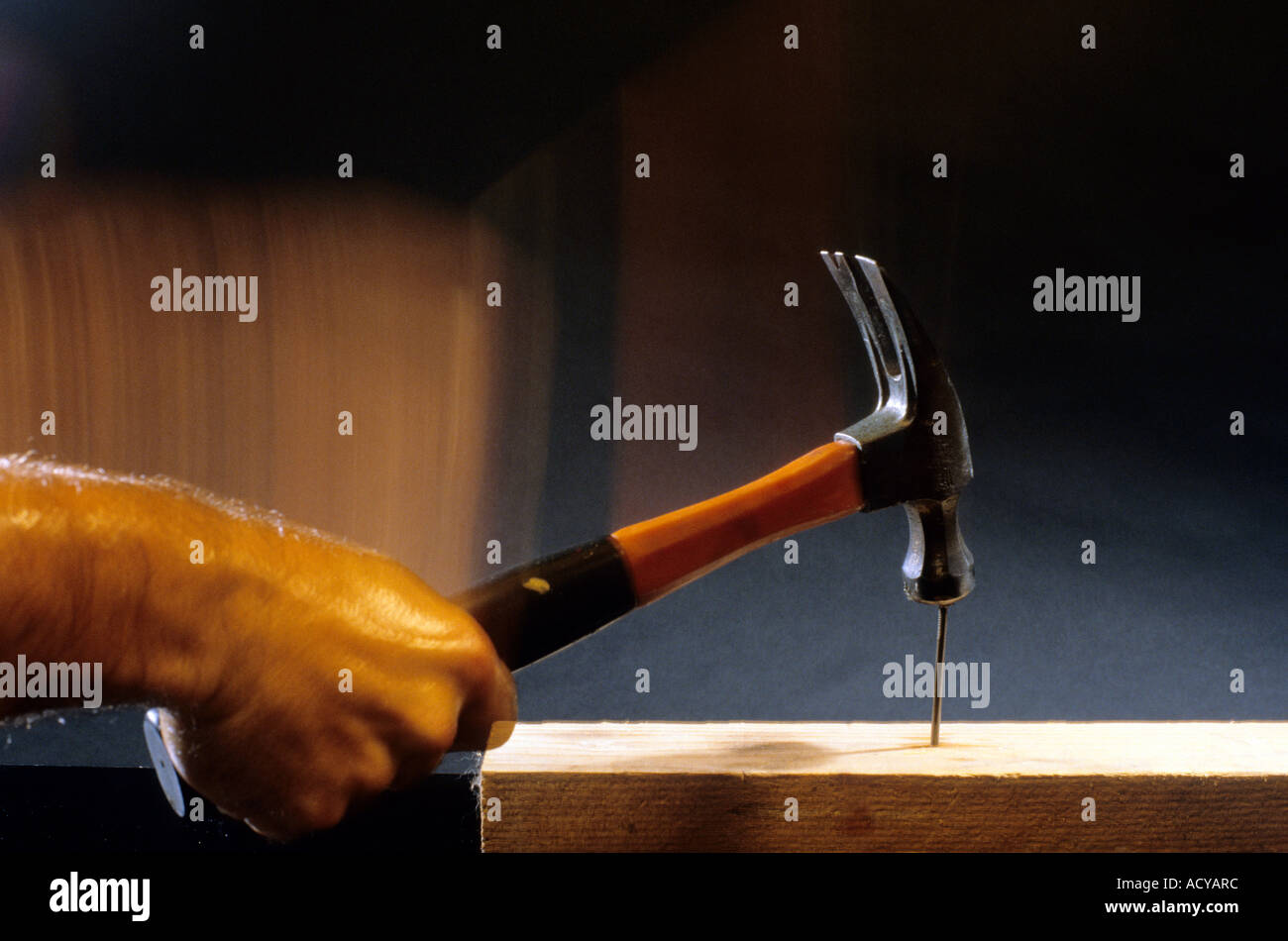 A hammer hitting a nail Stock Photo Alamy