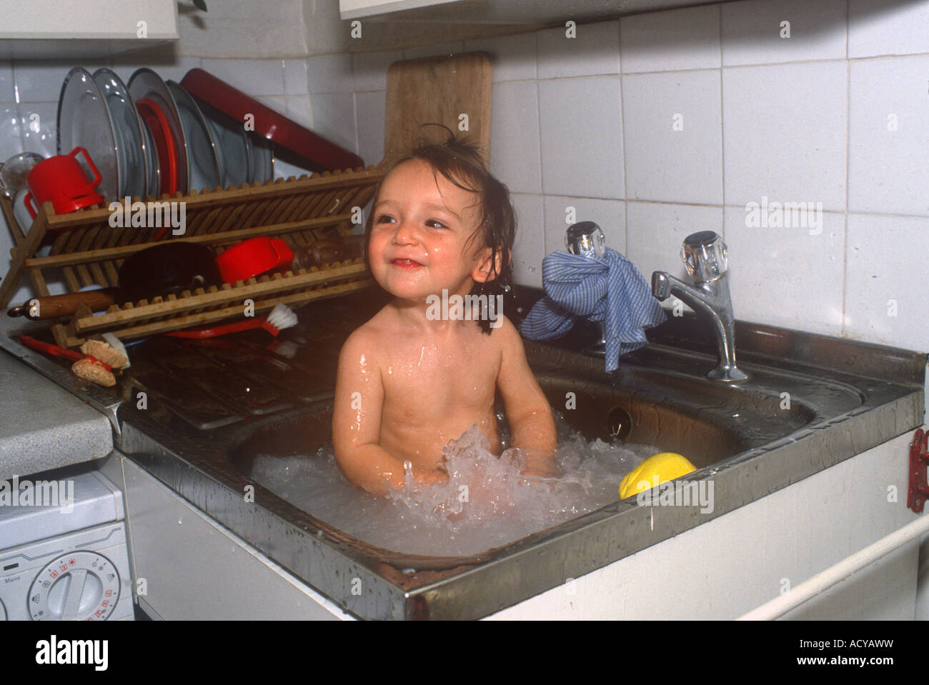 Baby Being Washed In Kitchen Sink Stock Photo 13253268 Alamy