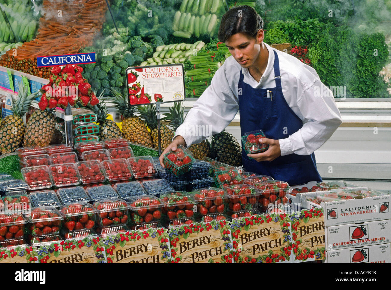 Grocery store STRAWBERRY display with clerk Stock Photo Alamy