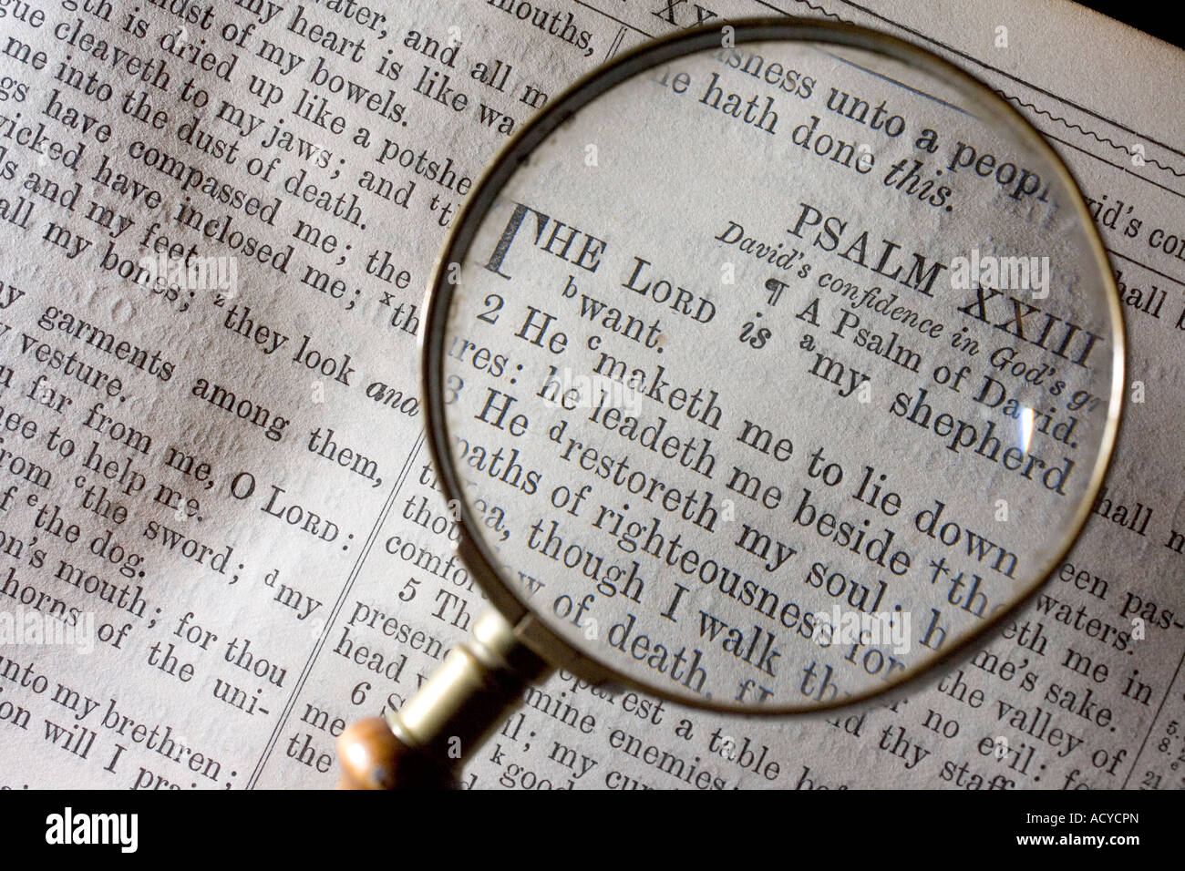 Magnifying glass looking at 23 psalm in bible looking Stock Photo Alamy
