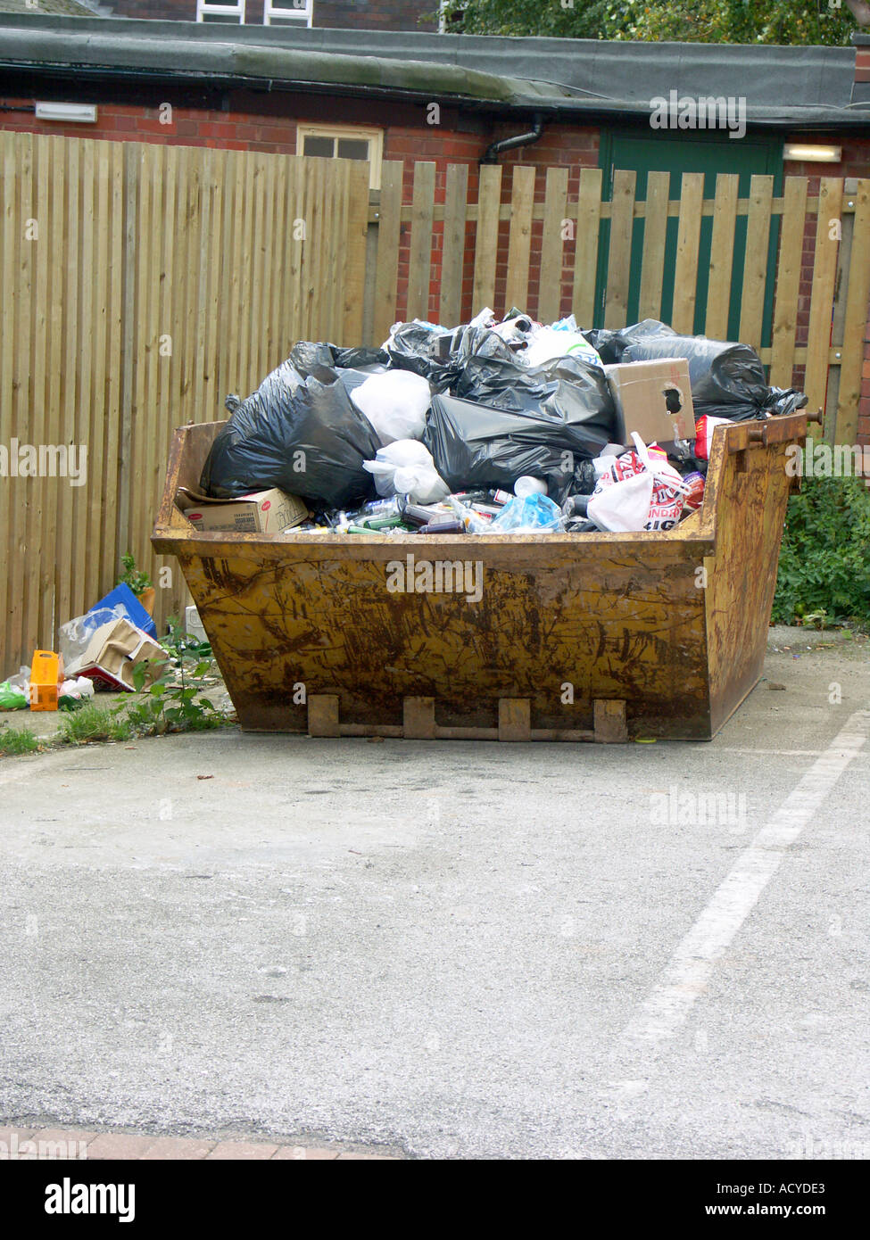 Rubbish Skip full with the usual assortment of black bags. Stock Photo