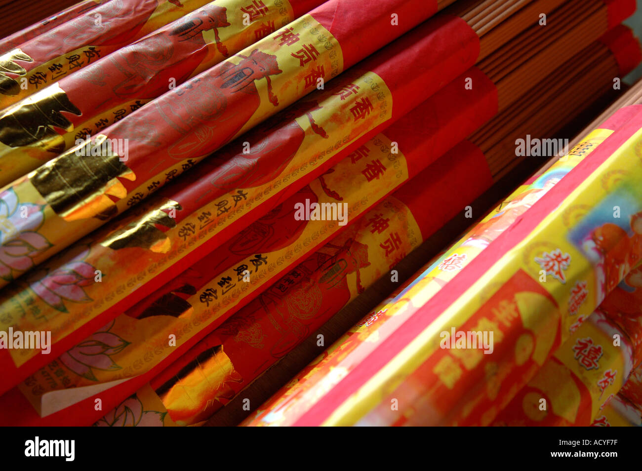 Packs of Chinese incense sticks wrapped in red and gold paper. For sale at market in Suzhou, China. Stock Photo