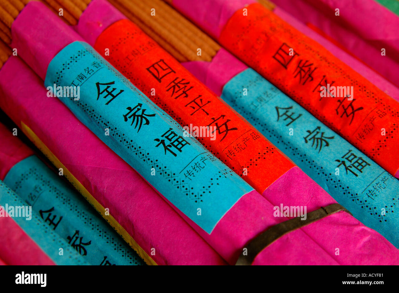 Packs of incense sticks wrapped in pink paper. For sale at market in Suzhou, China. Stock Photo