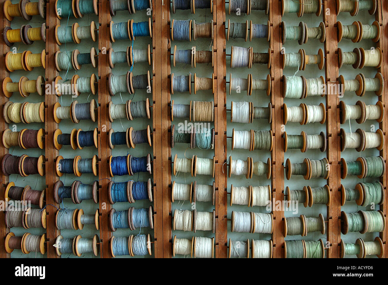 reels of coloured silk threads ready to be used in a carpet factory in Shanghai China Stock Photo