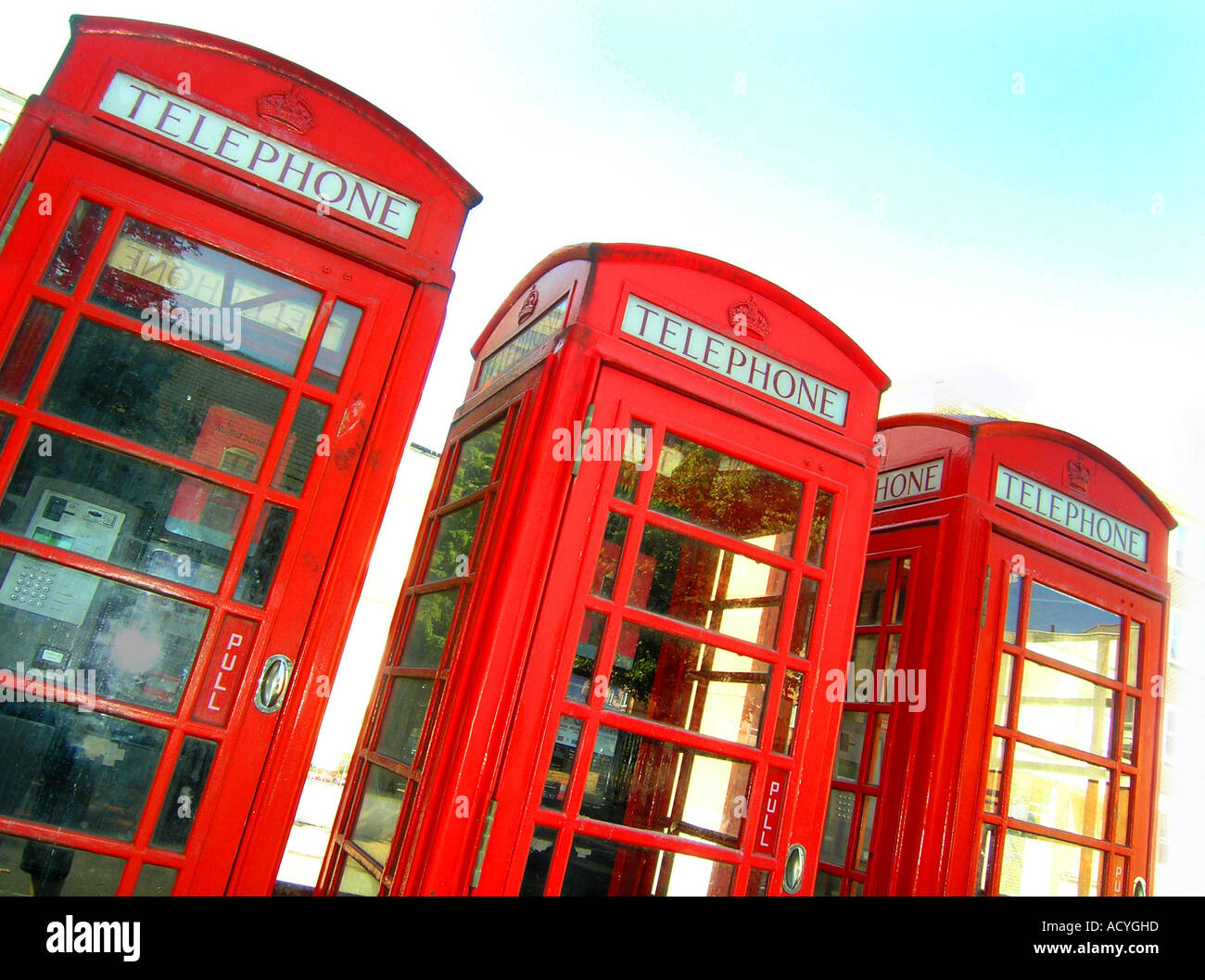 Three classic red phone boxes in Eastbourne Sussex England Stock Photo